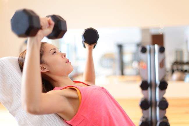 Woman lifting weights strength training